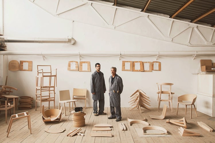 Two people standing in front of a room full of wooden furniture as a symbol of data driven 