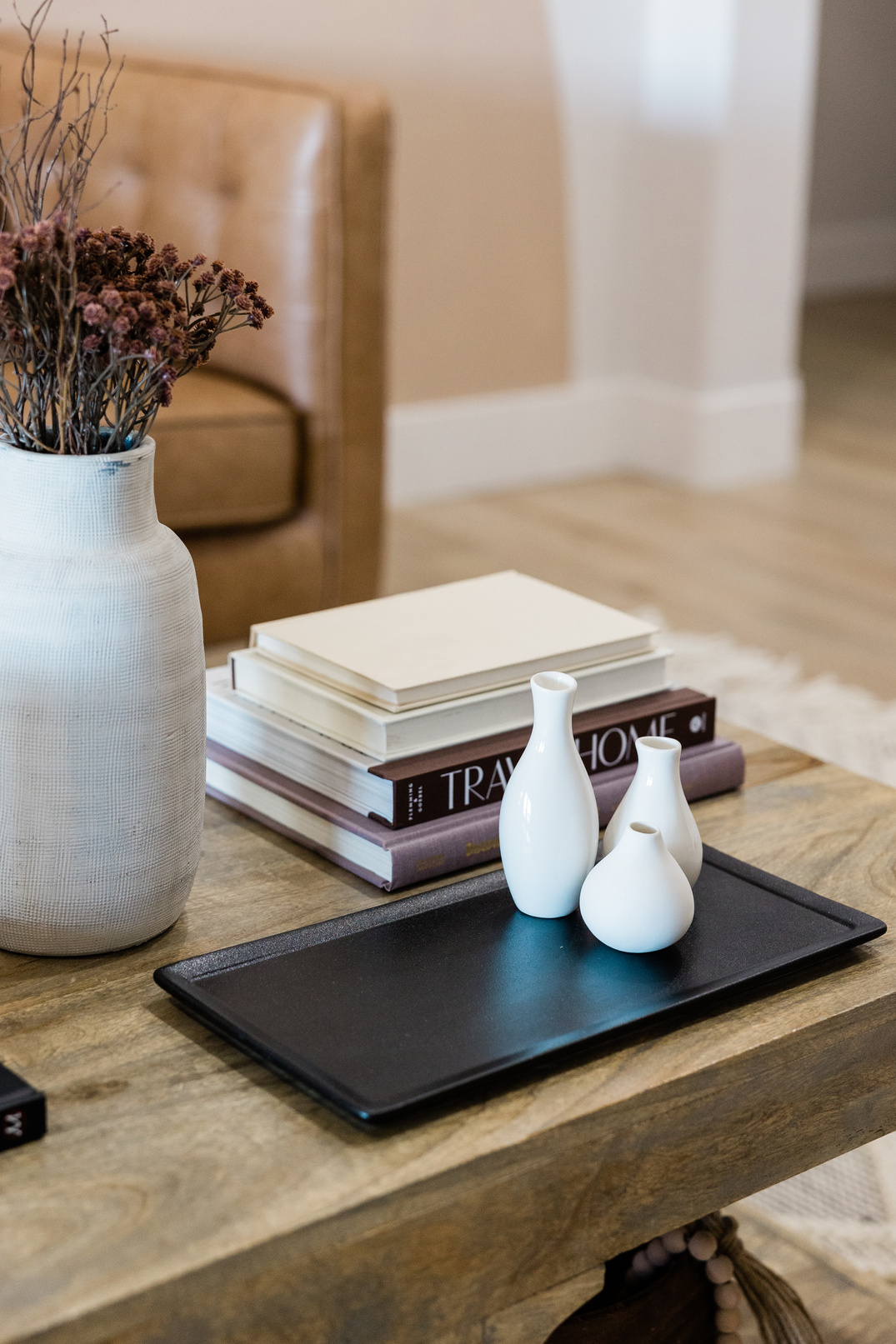 a coffee table with books and a vase on it